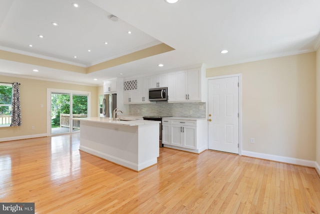 11013 Lopa Ln, North Potomac, MD 20878 - kitchen featuring appliances with stainless steel finishes, crown molding, light wood-type flooring, backsplash, and white cabinets