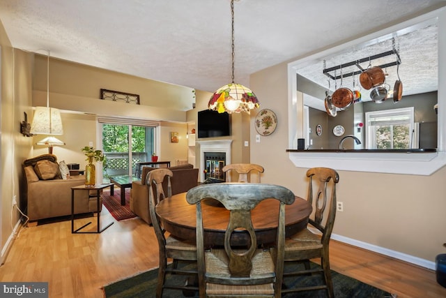 84 Windbrooke Cir Unit 84, Gaithersburg, MD 20879 - dining space featuring wood finished floors and a glass covered fireplace