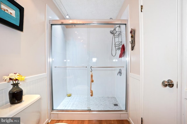 84 Windbrooke Cir Unit 84, Gaithersburg, MD 20879 - full bathroom featuring a shower stall, wainscoting, and a decorative wall