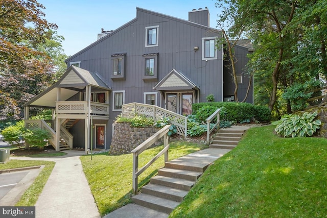 84 Windbrooke Cir Unit 84, Gaithersburg, MD 20879 - back of house featuring stairs, a chimney, and a lawn
