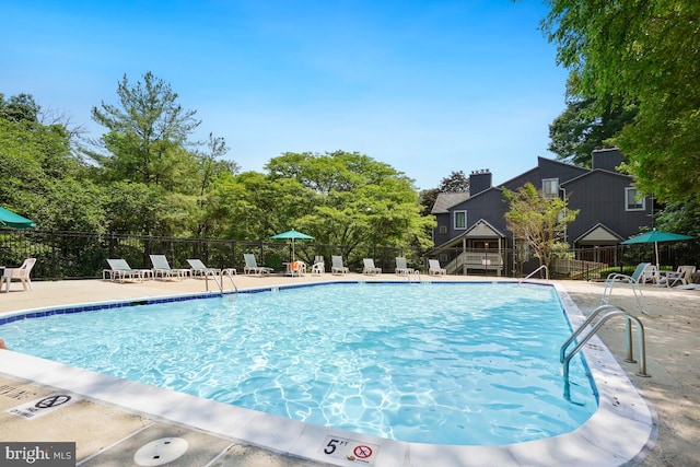 84 Windbrooke Cir Unit 84, Gaithersburg, MD 20879 - community pool with a patio area and view of scattered trees