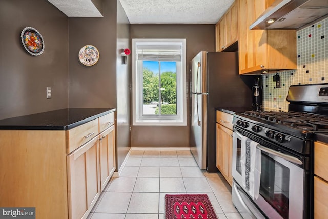 84 Windbrooke Cir Unit 84, Gaithersburg, MD 20879 - kitchen featuring stainless steel range with gas stovetop, ventilation hood, tasteful backsplash, light tile patterned floors, and dark countertops