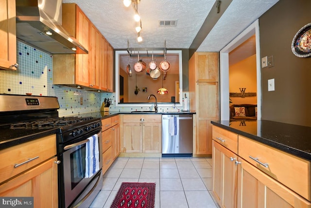84 Windbrooke Cir Unit 84, Gaithersburg, MD 20879 - kitchen featuring stainless steel appliances, wall chimney range hood, tasteful backsplash, a textured ceiling, and light tile patterned floors