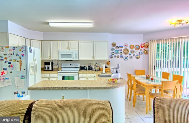 300 Bonnie Meadow Cir, Reisterstown, MD 21136 - kitchen with white appliances, light countertops, light tile patterned floors, and white cabinetry