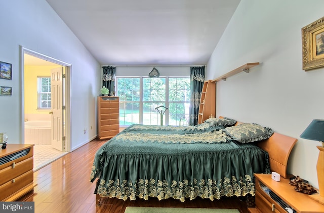 300 Bonnie Meadow Cir, Reisterstown, MD 21136 - bedroom with multiple windows, wood finished floors, lofted ceiling, and ensuite bath