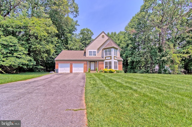 300 Bonnie Meadow Cir, Reisterstown, MD 21136 - view of front of property with driveway, a garage, brick siding, and a front lawn