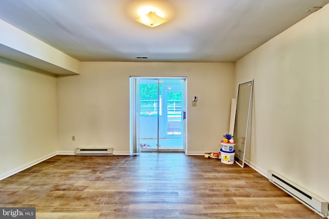 300 Bonnie Meadow Cir, Reisterstown, MD 21136 - spare room with a baseboard heating unit and wood finished floors