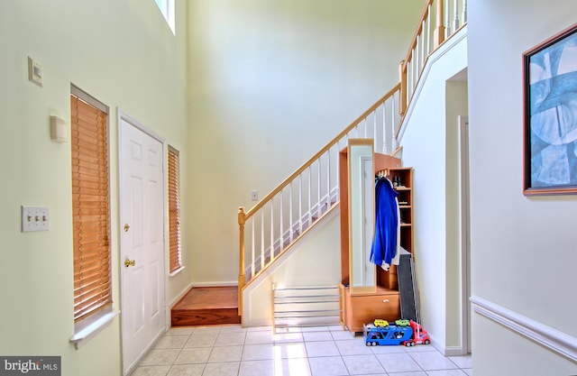 300 Bonnie Meadow Cir, Reisterstown, MD 21136 - entryway featuring tile patterned flooring, stairway, and a towering ceiling