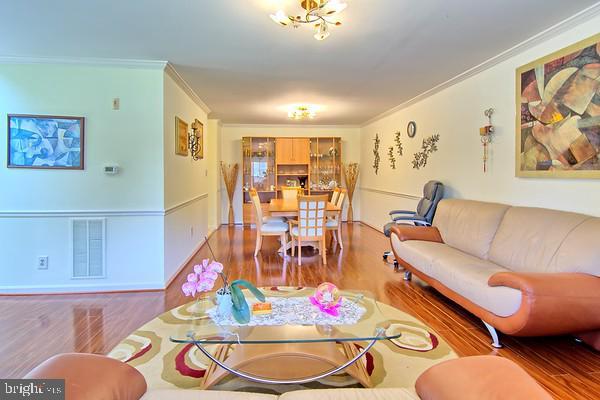 300 Bonnie Meadow Cir, Reisterstown, MD 21136 - living room featuring wood finished floors and crown molding