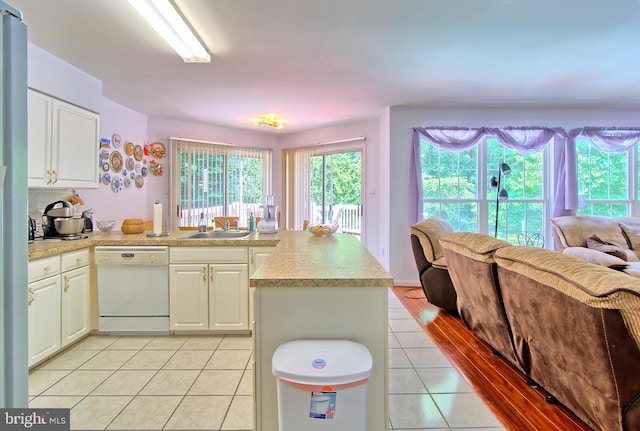 300 Bonnie Meadow Cir, Reisterstown, MD 21136 - kitchen featuring white dishwasher, light tile patterned flooring, open floor plan, a peninsula, and light countertops
