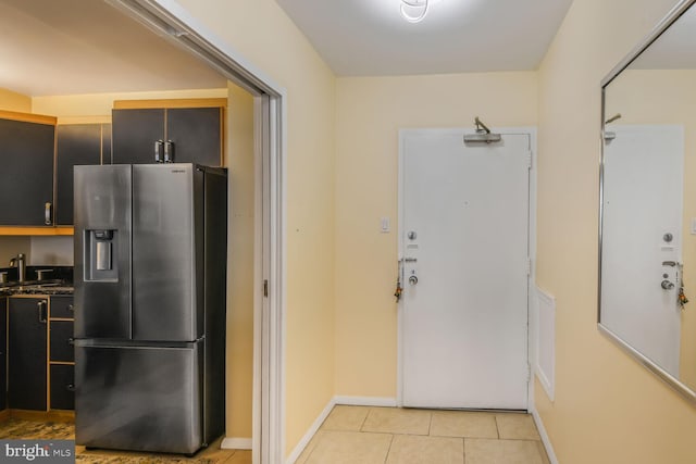 4515 Willard Ave Unit 1111S, Chevy Chase, MD 20815 - kitchen featuring stainless steel fridge with ice dispenser, light tile patterned floors, and dark countertops