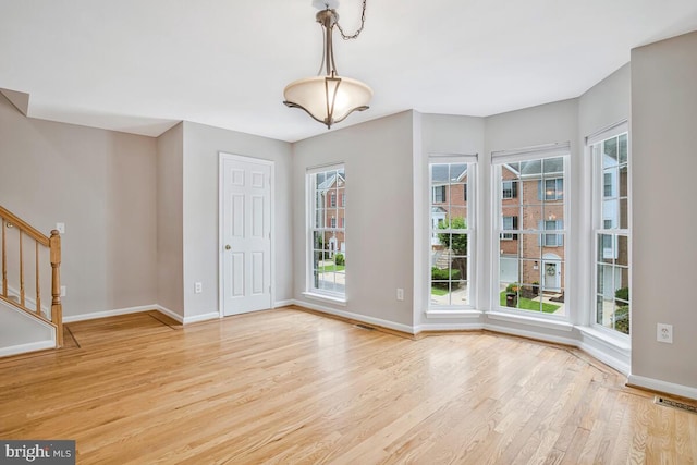 1403 Peregrine Path, Arnold, MD 21012 - unfurnished dining area featuring light wood-style floors, plenty of natural light, and stairs