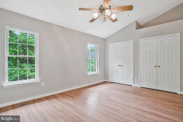 1403 Peregrine Path, Arnold, MD 21012 - unfurnished bedroom featuring multiple closets, lofted ceiling, light wood-style floors, and a ceiling fan