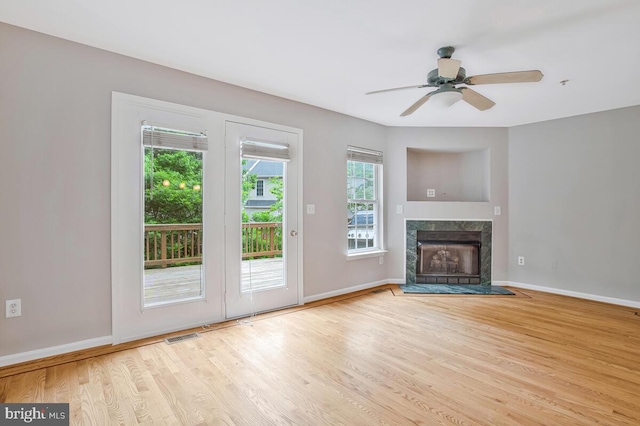 1403 Peregrine Path, Arnold, MD 21012 - unfurnished living room featuring wood finished floors, a ceiling fan, and a high end fireplace