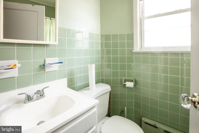 77 Atkins Ave, Hamilton, NJ 08610 - bathroom with tile walls, vanity, and a baseboard radiator