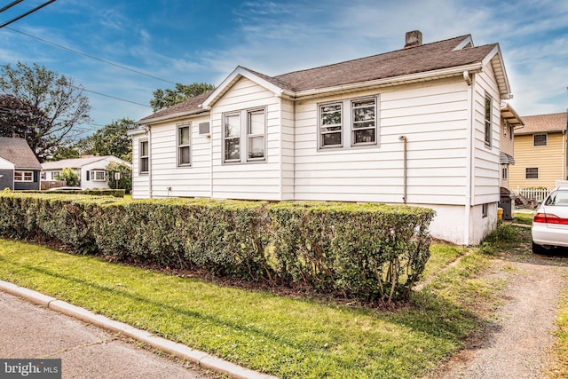 77 Atkins Ave, Hamilton, NJ 08610 - view of front of home with a chimney, a front yard, and a shingled roof