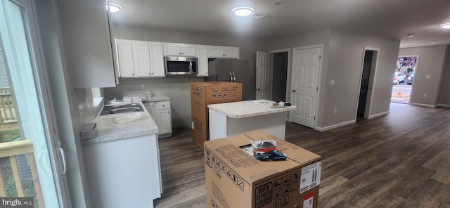 48 Petersburg Ln, Duncannon, PA 17020 - kitchen with stainless steel microwave, a kitchen island, white cabinetry, and dark wood-style flooring