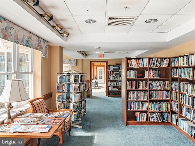 7101 Bay Front Dr Unit 204, Annapolis, MD 21403 - living area featuring carpet flooring, wall of books, and a paneled ceiling