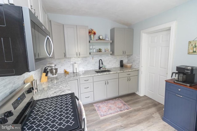 213 Conover St, Burlington, NJ 08016 - kitchen with appliances with stainless steel finishes, decorative backsplash, light wood-type flooring, lofted ceiling, and open shelves