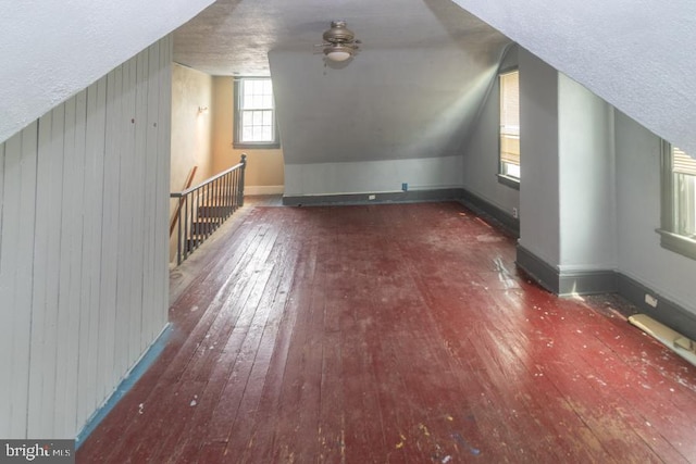 213 Conover St, Burlington, NJ 08016 - additional living space with hardwood / wood-style floors, ceiling fan, wood walls, vaulted ceiling, and a textured ceiling
