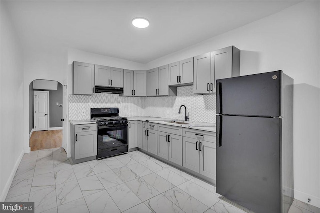 906 N 4th St, Camden, NJ 08102 - kitchen featuring black appliances, gray cabinetry, light countertops, and light marble finish flooring