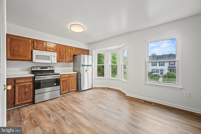 34 Ingate Ter Unit 4410, Halethorpe, MD 21227 - kitchen with appliances with stainless steel finishes, light wood-style floors, light countertops, and brown cabinets