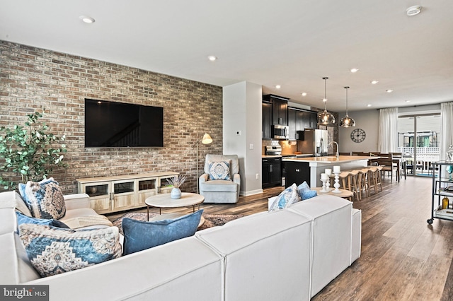 1036 Cantina Ter SE, Leesburg, VA 20175 - living area with wood finished floors, recessed lighting, and brick wall