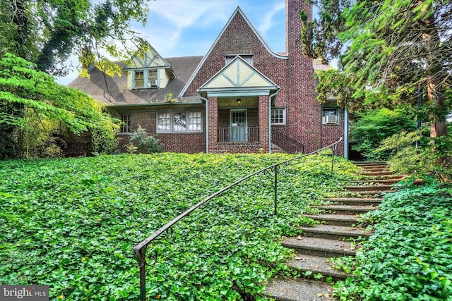 100 Springdale Rd, York, PA 17403 - english style home featuring stairway, a chimney, and brick siding
