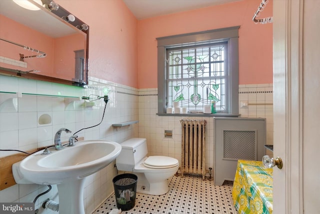 100 Springdale Rd, York, PA 17403 - bathroom with radiator heating unit, tile walls, and a wainscoted wall