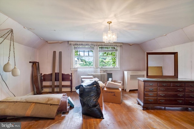 100 Springdale Rd, York, PA 17403 - living area featuring vaulted ceiling, wood finished floors, a chandelier, and radiator