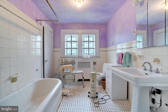 100 Springdale Rd, York, PA 17403 - full bathroom with tile walls, a bath, a wainscoted wall, and tile patterned floors