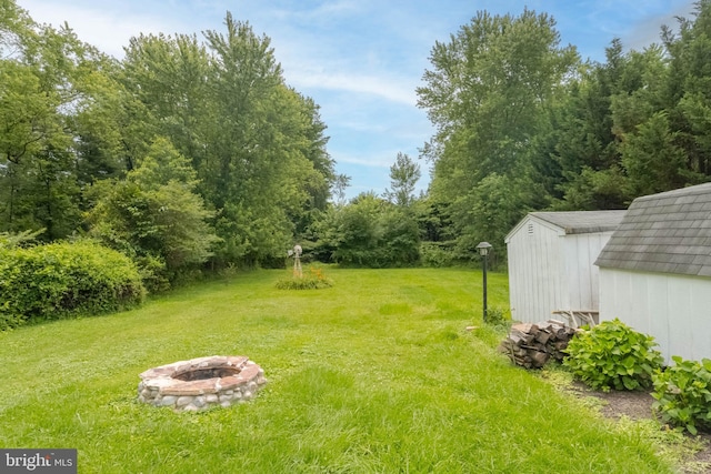 101 E Macphail Rd, Bel Air, MD 21014 - view of green lawn featuring a fire pit and a storage shed