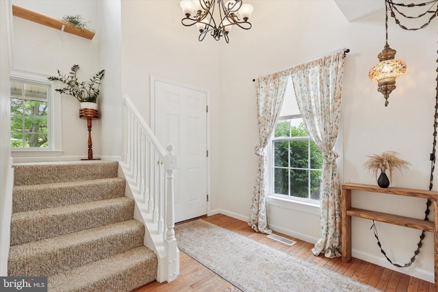 1009 Red Rock Cir, Royersford, PA 19468 - foyer entrance featuring hardwood / wood-style flooring, plenty of natural light, stairway, a chandelier, and a high ceiling