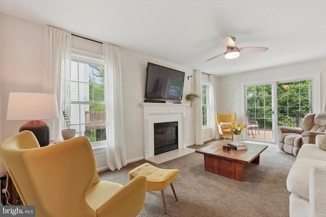 1009 Red Rock Cir, Royersford, PA 19468 - living room featuring a fireplace with flush hearth, plenty of natural light, ceiling fan, and carpet floors