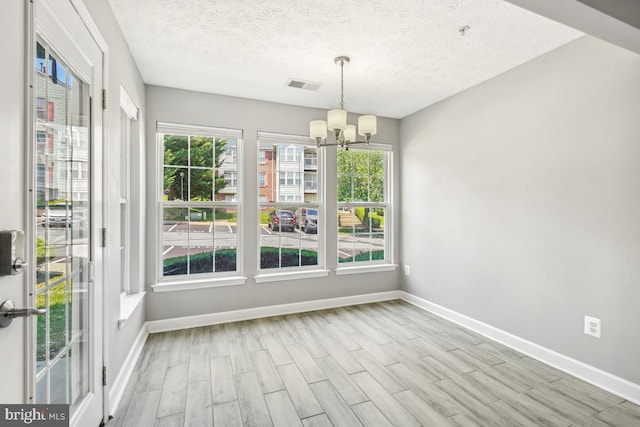 25909 Ridge Manor Dr Unit A, Damascus, MD 20872 - unfurnished dining area with a chandelier, wood finished floors, and a textured ceiling