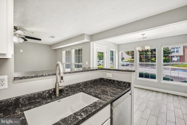 25909 Ridge Manor Dr Unit A, Damascus, MD 20872 - kitchen with dishwasher, white cabinetry, dark stone countertops, and a textured ceiling