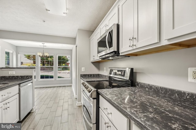 25909 Ridge Manor Dr Unit A, Damascus, MD 20872 - kitchen with stainless steel appliances, white cabinets, light wood-style flooring, a chandelier, and dark stone countertops