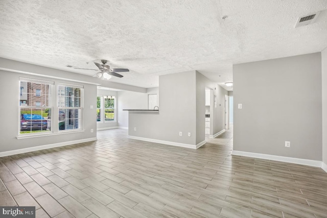 25909 Ridge Manor Dr Unit A, Damascus, MD 20872 - unfurnished living room with a ceiling fan, a textured ceiling, and wood finished floors