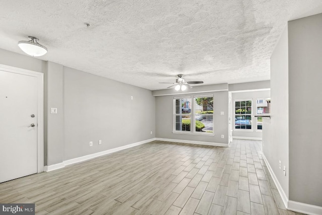 25909 Ridge Manor Dr Unit A, Damascus, MD 20872 - unfurnished living room with ceiling fan, wood finished floors, and a textured ceiling