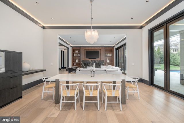 1020 Langley Hill Dr, Mclean, VA 22101 - kitchen with a breakfast bar area, a chandelier, light wood finished floors, hanging light fixtures, and ornamental molding