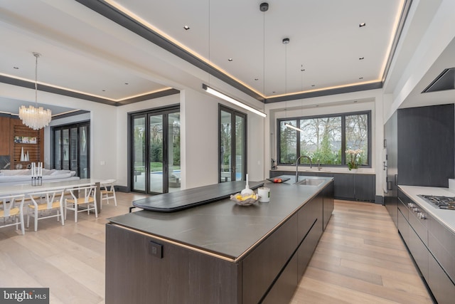1020 Langley Hill Dr, Mclean, VA 22101 - kitchen featuring modern cabinets, open floor plan, light wood finished floors, and a chandelier
