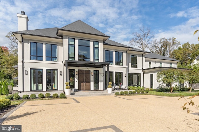 1020 Langley Hill Dr, Mclean, VA 22101 - view of front facade with a chimney and stucco siding