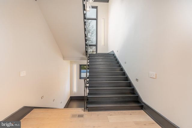 1020 Langley Hill Dr, Mclean, VA 22101 - staircase with plenty of natural light, wood finished floors, and a towering ceiling