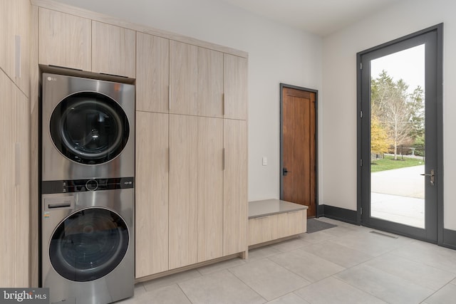 1020 Langley Hill Dr, Mclean, VA 22101 - laundry room with stacked washer / drying machine, light tile patterned flooring, and cabinet space