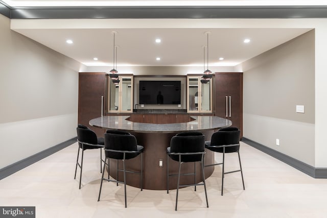 1020 Langley Hill Dr, Mclean, VA 22101 - kitchen featuring a spacious island, a kitchen breakfast bar, glass insert cabinets, dark brown cabinetry, and recessed lighting