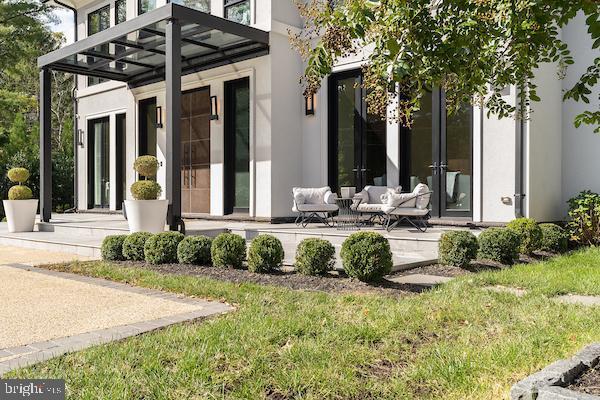 1020 Langley Hill Dr, Mclean, VA 22101 - rear view of house with stucco siding, a lawn, and french doors