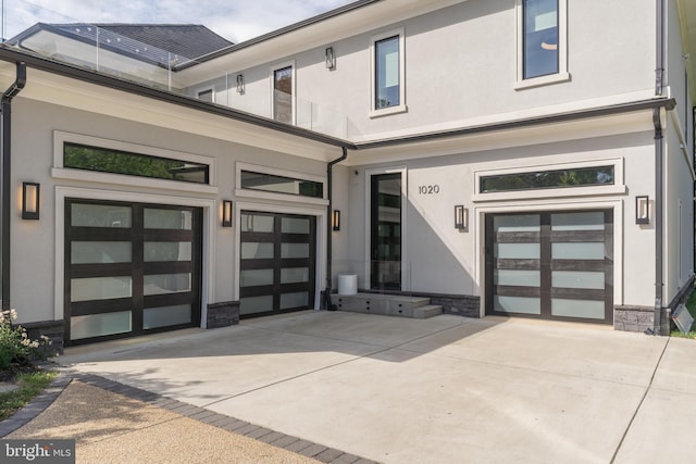 1020 Langley Hill Dr, Mclean, VA 22101 - property entrance featuring concrete driveway, stucco siding, and stone siding