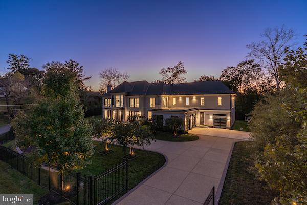 1020 Langley Hill Dr, Mclean, VA 22101 - view of front of home with curved driveway, an attached garage, and a chimney