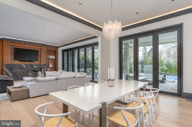 1020 Langley Hill Dr, Mclean, VA 22101 - dining space featuring french doors, light wood finished floors, plenty of natural light, and a chandelier