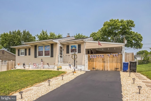3 Cawdor Ln, New Castle, DE 19720 - view of front of house with asphalt driveway, a carport, and a chimney